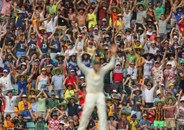 The crowd celebrates after Australia's Steven Smith, centre, took a catch to dismiss Ian Bell as England were left reeling on day two of the first Ashes Test. Picture: Getty