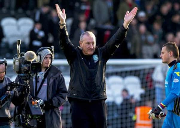 Terry Butcher acknowledges the crowd in his first game in charge as Hibs manager. Picture: SNS
