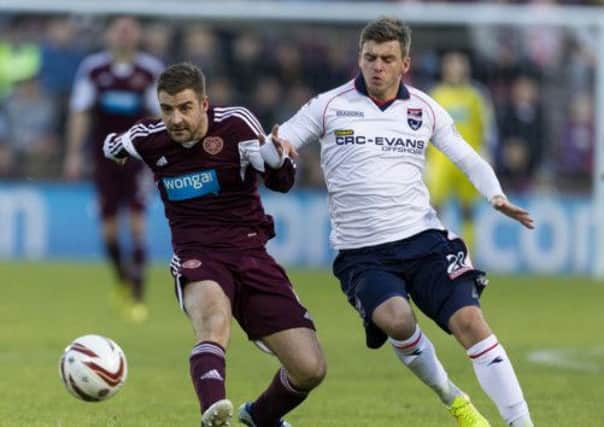 Scott Robinson (left) battles for the ball with Ross County's Graham Carey. Picture: SNS