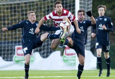 Hamilton's Tony Andreu, centre, is challenged by Jim McAlister, left, and Peter MacDonald. Picture: SNS