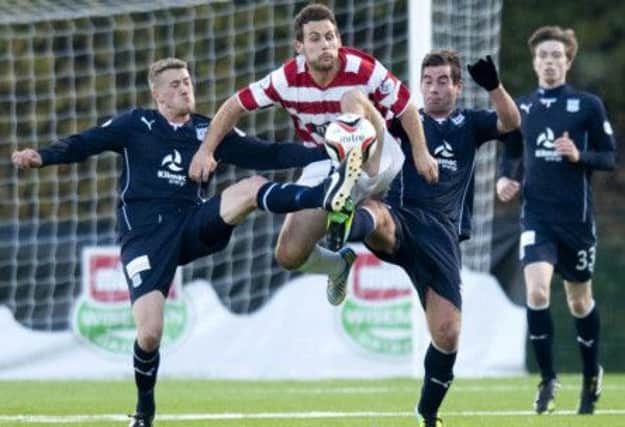 Hamilton's Tony Andreu, centre, is challenged by Jim McAlister, left, and Peter MacDonald.  Picture: SNS