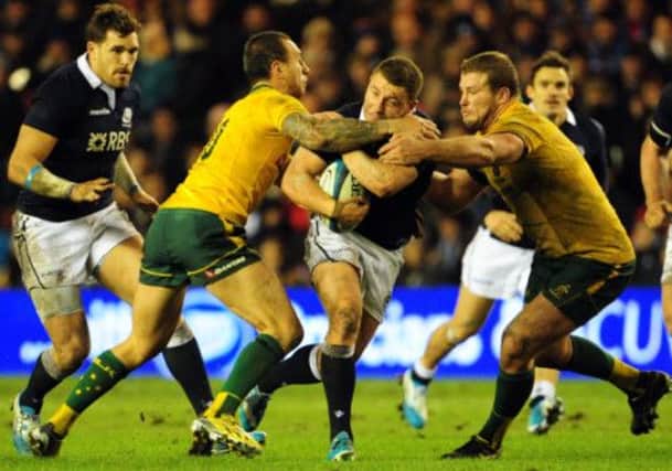 Scotland's Duncan Weir, centre, is tackled by Quade Cooper, left, and James Slipper during yesterday's defeat to Australia. Picture: Ian Rutherford