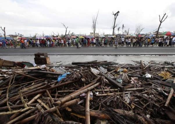 Typhoon survivors make their way from a Mass for the disaster's victims. Picture: AP