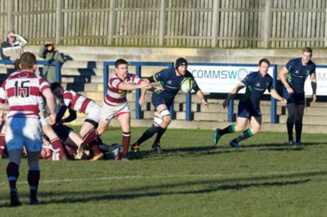 Watsonians' Chris Hunter clears from a ruck as Greg Scott, of Boroughmuir, chases. Picture: Joey Kelly