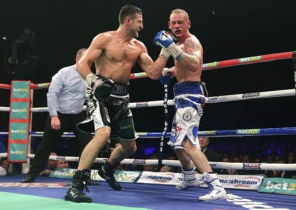 Champion Carl Froch lands a left-hand shot on the chin of George Groves. Picture: PA