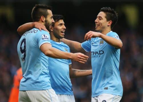 Manchester City's Alvaro Negredo, left, celebrates the fifth goal against Spurs with teammates Sergio Aguero, centre, and Samir Nasri. Picture: Getty