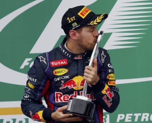 Sebastian Vettel celebrates after maintaining his allconquering run by clinching the Brazilian Grand Prix in Sao Paulo yeterday. Picture: Paulo Whitaker/Reuters