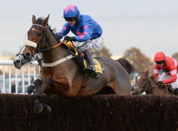 Cue Card and Joe Tizzard on their way to victory in the Betfair Chase at Haydock. Picture: PA