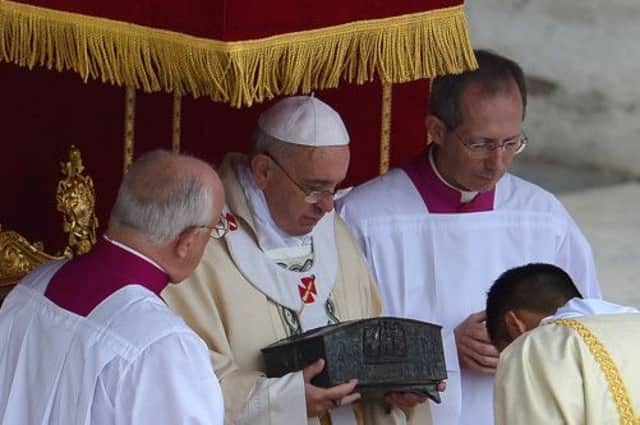Pope Francis holds a casket containing the bone fragments of St Peter during a Mass in Rome yesterday. Picture: Getty