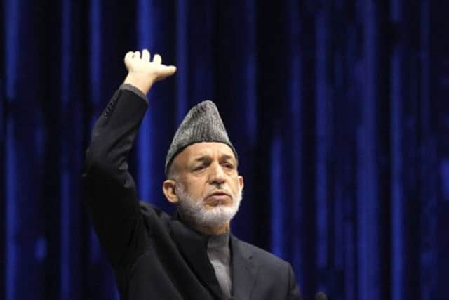 President Hamid Karzai at the Loya Jirga  or Grand Council  after yesterday's controversial announcement. Picture: Reuters