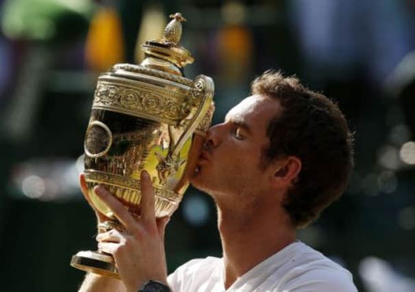 Andy Murray celebrates with the Wimbledon trophy after defeating Novak Djokovic in the men's final in July. Picture: PA