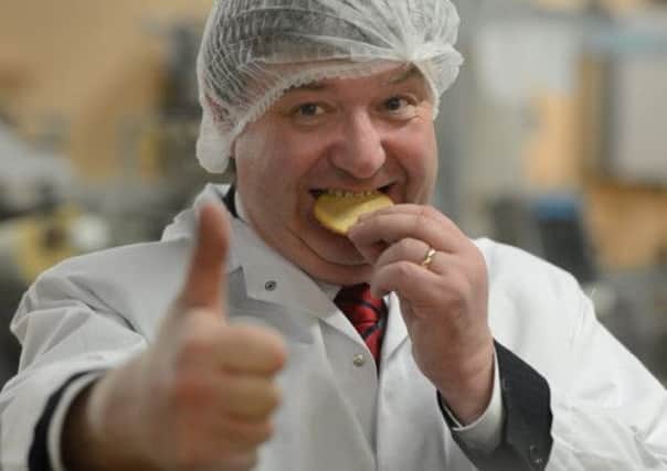 Alistair Carmichael treats himself to an oatcake at Nairn's Oatcakes in Edinburgh. Picture: Neil Hanna