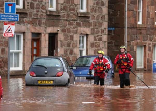 Fireman on the high street in Stonehaven during last year's floods. Picture: PA