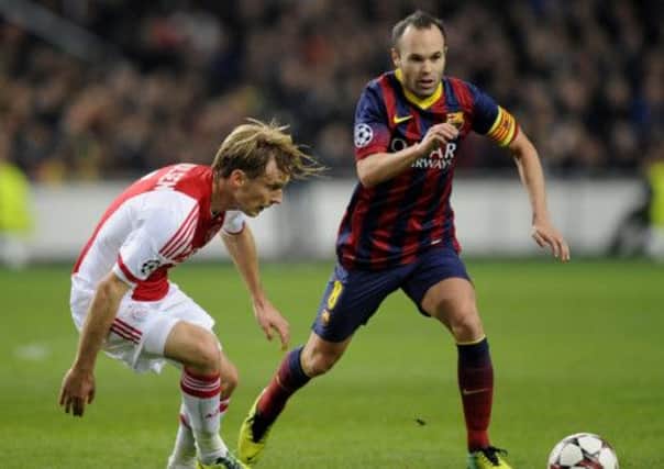 Andres Iniesta vies for the ball with Ajax Amsterdam's Danish midfielder Christian Poulsen. Picture: Getty