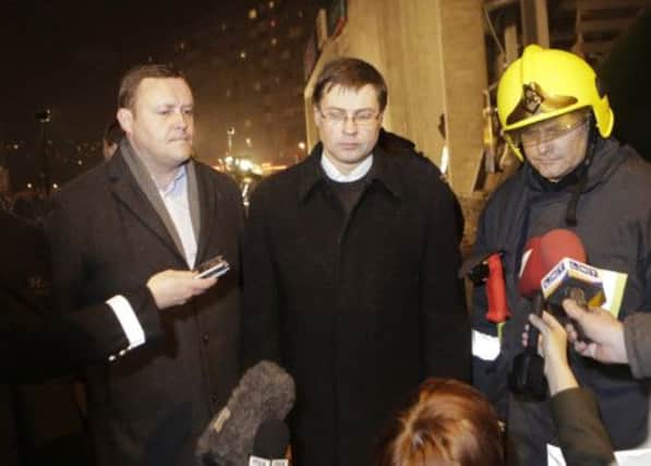 Valdis Dombrovskis, centre, speaks to the media after the supermarket collapse. Picture: Reuters
