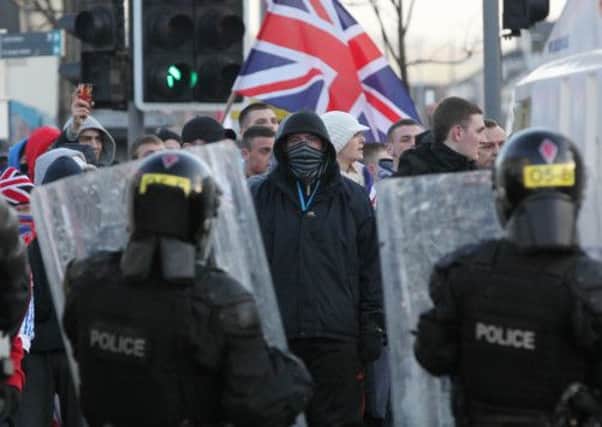 Police try to contain loyalists after a march in protest against restrictions on flying the Union Flag. Picture: AFP/Getty