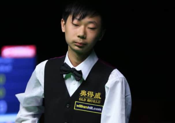 Lyu Haotian from China during his first round defeat by Scotland's Marcus Campbell. Picture: PA