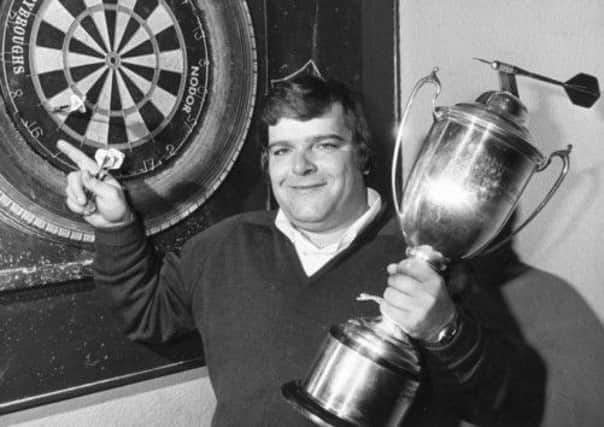 Jocky Wilson with the Embassy Darts World Championship trophy in 1982. Picture: TSPL