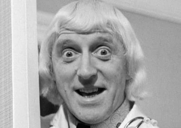 File photo of Jimmy Savile visiting Leeds General Infirmary. 19 hospitals face a probe into their links with Savile. Picture: PA