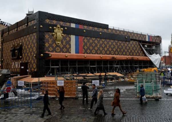 People walk past a giant Louis Vuitton trunk on Red Square in Moscow. Picture: Getty