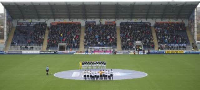 Both teams observe a minutes silence in honour of the Glasgow helicopter crash. Picture: SNS