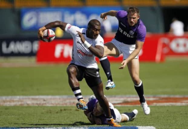 Fijis Samu Saqiwa evades a tackle by Scotlands Mark Robertson in the quarter-final. Picture: Reuters