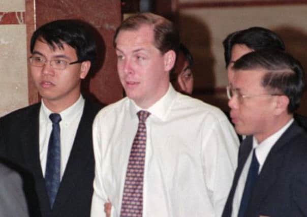 Trader Nick Leeson, centre, was jailed on this day in 1995 for his part in the £860 million collapse of Barings Bank. Picture: AP