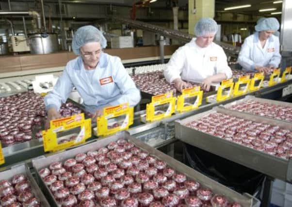 Workers pack teacakes at the Tunnocks factory at Uddingston, Lanarkshire. Picture: Robert Perry