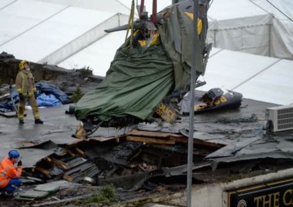 The helicopter is pulled from the wreckage on the roof of the Clutha Vaults. Picture: Getty