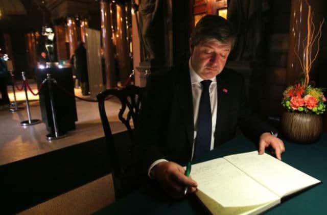 Scottish Secretary Alistair Carmichael signs the book of condolence at Glasgow City Chambers. Picture: PA
