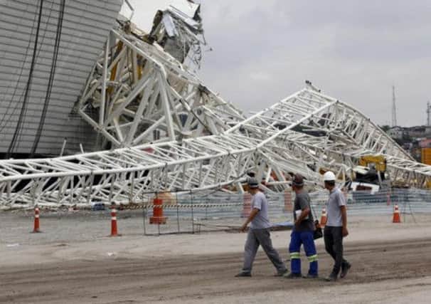 Workers survey the damage at the Arena Sao Paulo stadium. Picture: Sao Paulo