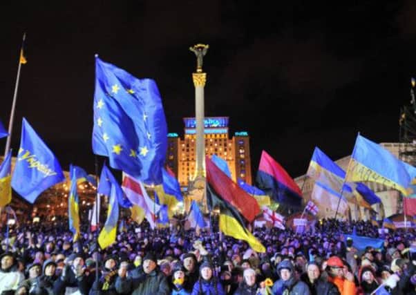 The crowd in Independence Square waved Ukraine and European Union flags on Monday night. Picture: Getty