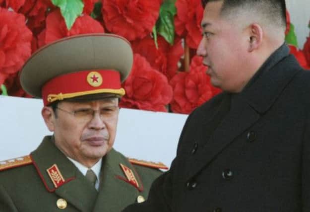 Jang Song-thaek, left, with Kim Jong-un. Picture: Reuters