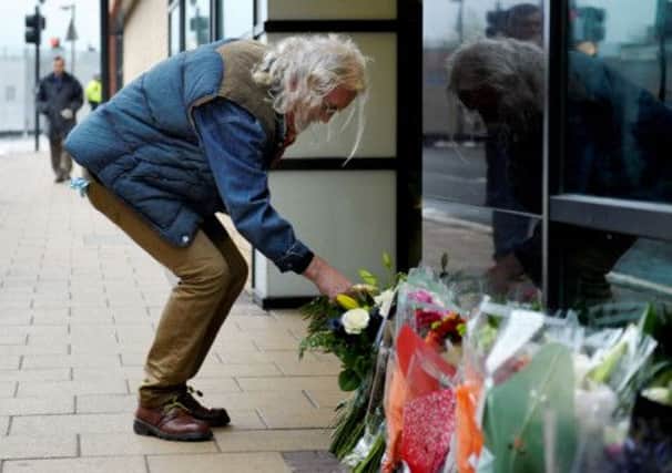 Billy Connolly lays flowers close to the Clutha where nine people died. Picture: HEMEDIA