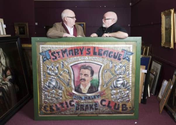 Owner Thomas Carberry (left) and former owner Jim Mullin (right) with the St Mary's League Brake Banner. Picture: PA