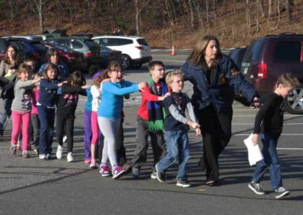 Connecticut State Police lead a line of children from the Sandy Hook Elementary School. Picture: AP