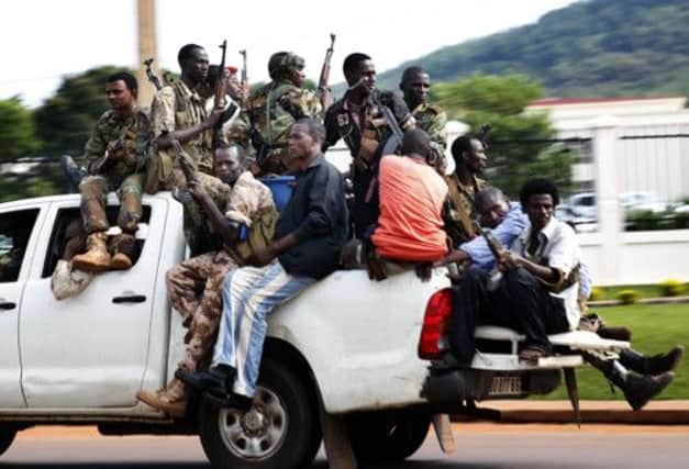 Seleka militiamen race through Bangui yesterday. Picture: AP
