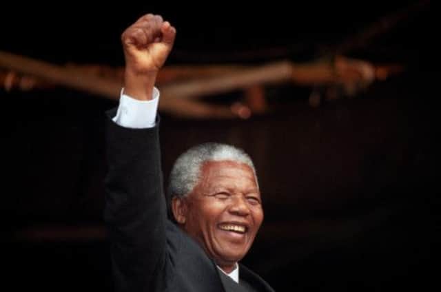 Nelson Mandela acknowledging the crowd at a rally in Glasgow in 1993. Picture: PA