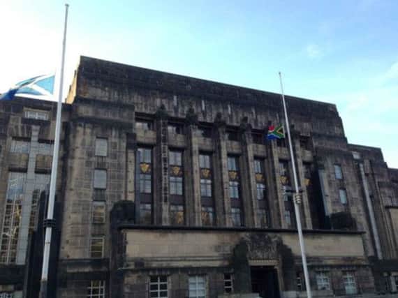 The Saltire at half mast alongside the South African flat outside the Scottish Government offices in Edinburgh
