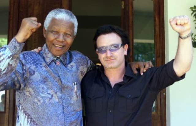 Bono with Nelson Mandela in 2002. Picture: AP