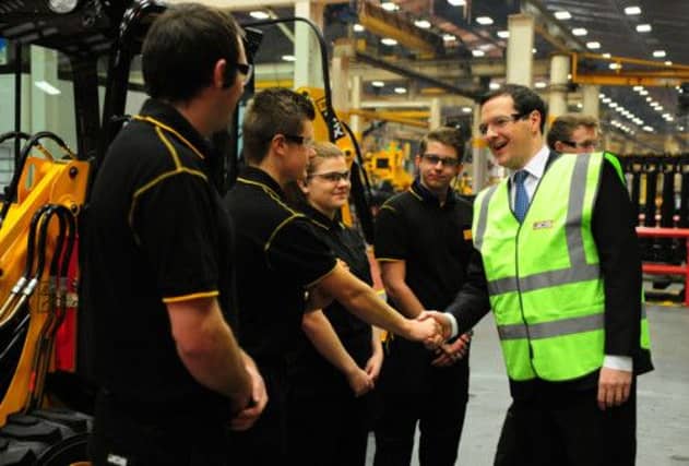 The Chancellor of the Exchequer George Osborne meets apprentices during a visit to JCB's backhoe loader factory in Rocester. Picture: PA
