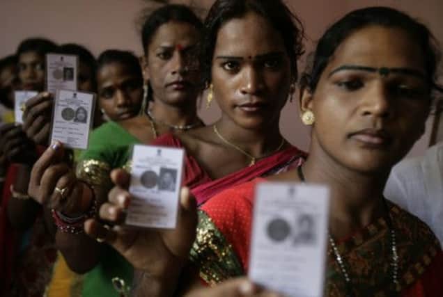 Indian eunuchs hold up their voter cards. Picture: AP
