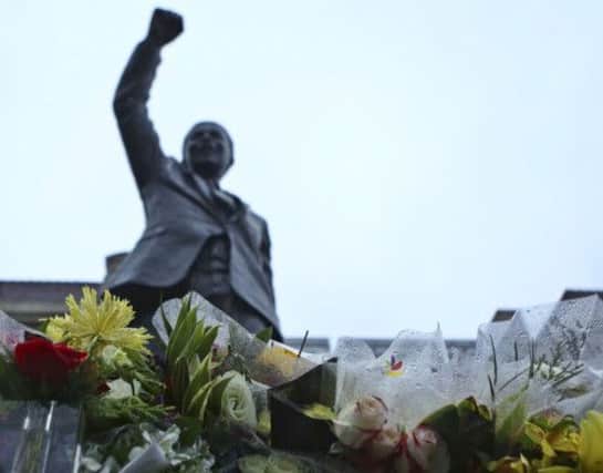 A statue of Nelson Mandela is surrounded by flowers outside of the South African Embassy in Washington. Picture: Reuters