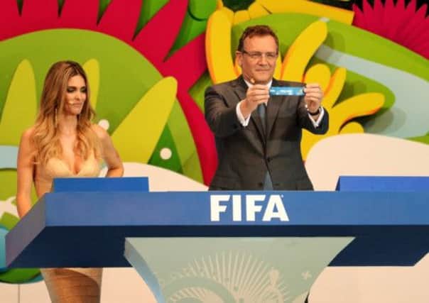 Fifa secretary general Jerome Valcke holds up the name of England during yesterday's draw for next summer's World Cup finals in Brazil. Picture: Getty