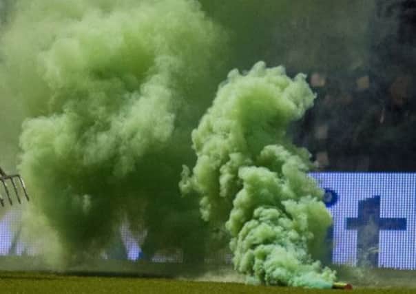 A smoke bomb is thrown onto the pitch. Picture: SNS