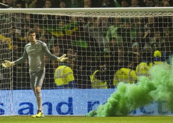 Smoke engulfs Celtic keeper Fraser Forster's goal. Picture: SNS