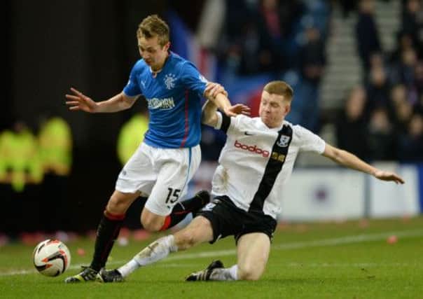 Robbie Crawford (left) is tackled by Ayr's Craig Malcolm. Picture: SNS