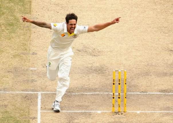 Mitchell Johnson celebrates taking the wicket of England captain Alastair Cook. Picture: Getty