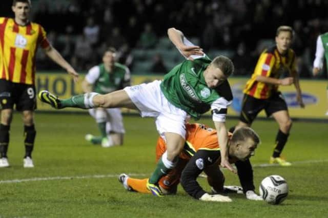 Hibs substitute Jason Cummings tangles with Partick goalkeeper Scott Fox as the hosts searched for an equaliser. Picture: Greg Macvean