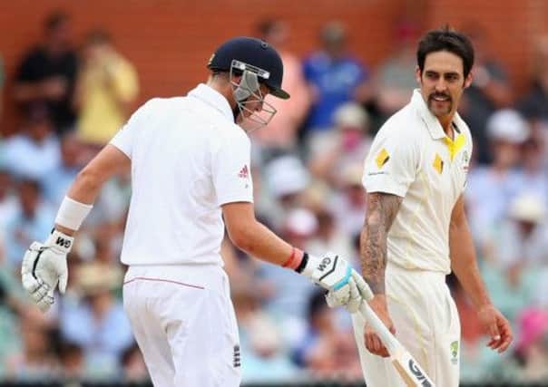 England batsman Joe Root and Australia's dominant bowler Mitchell Johnson exchange words at the crease in Adelaide. Picture: Getty